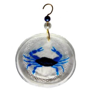 circular glass ornament with a painted blue crab